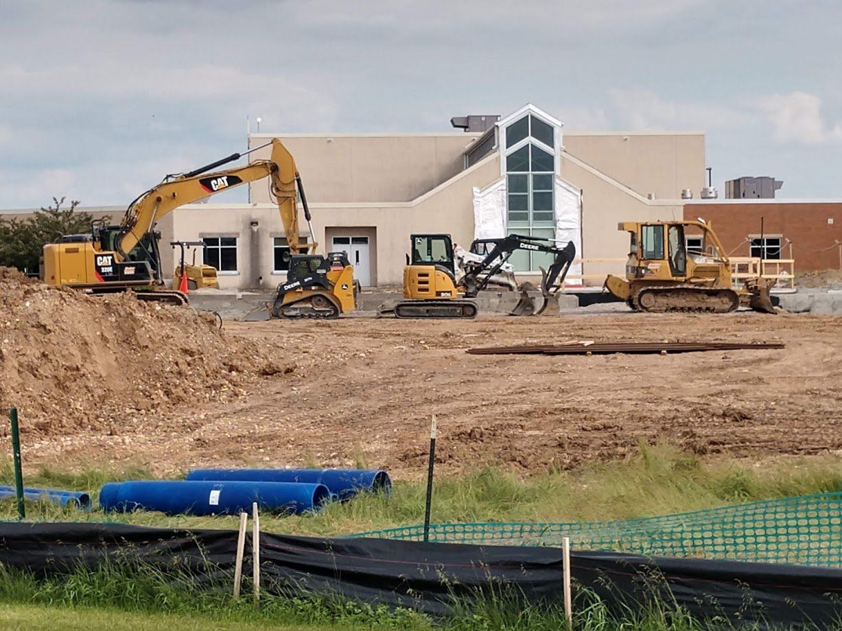 Vehicles clearling land infront of a church
