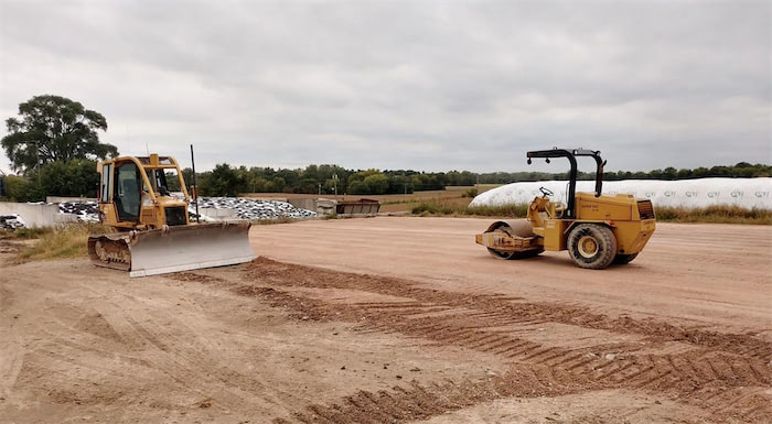 Bulldozer and a steamroller at work